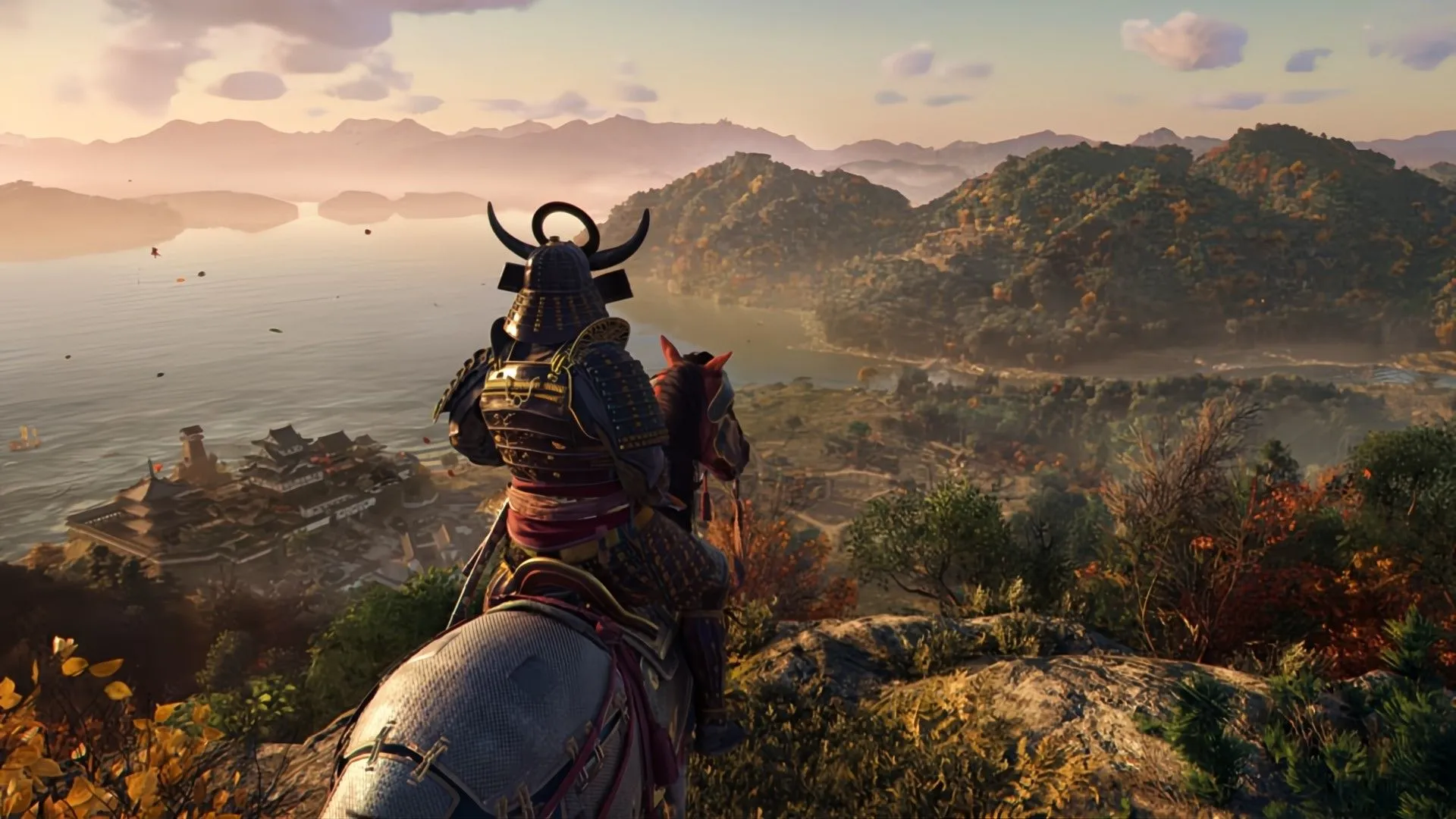 Cảnh từ game Assassin's Creed Shadows, hiển thị một samurai nhìn ra từ vách đá hướng về một xã hội truyền thống Nhật Bản