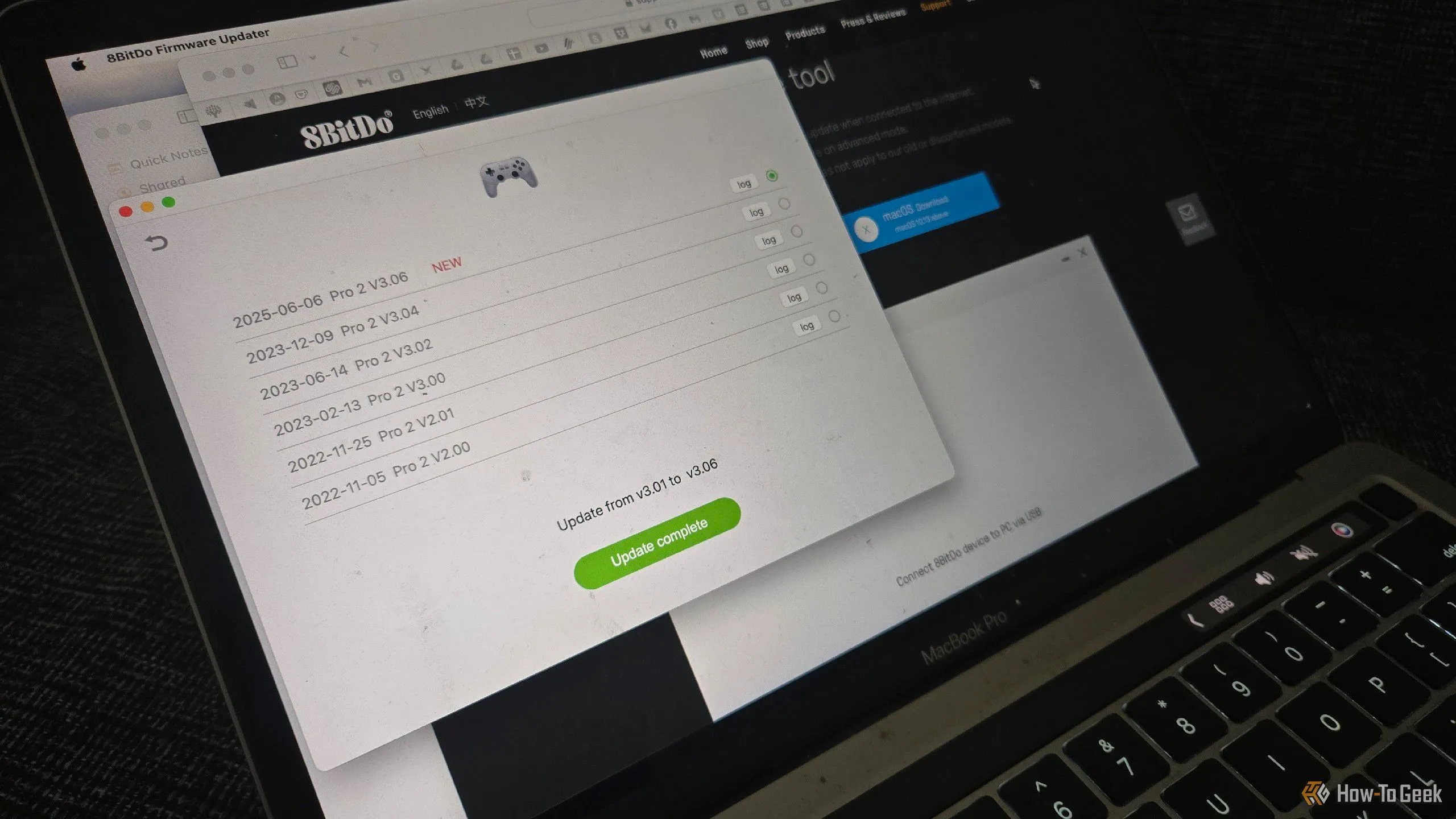 Tay cầm chơi game 8BitDo Pro 2 đang được cập nhật firmware thông qua MacBook, minh họa sự phụ thuộc vào PC cho các tác vụ này.