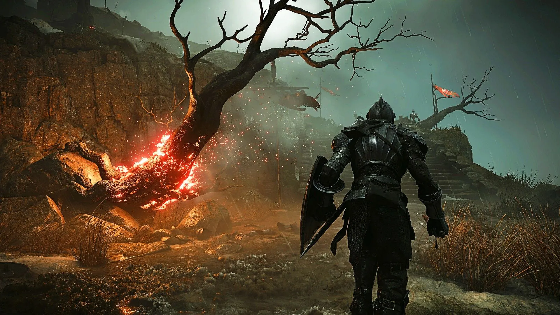 Người chơi đang di chuyển qua một cây cháy trong khu vực Shrine of Storms của tựa game Demon's Souls remake, thể hiện đồ họa thế hệ mới.