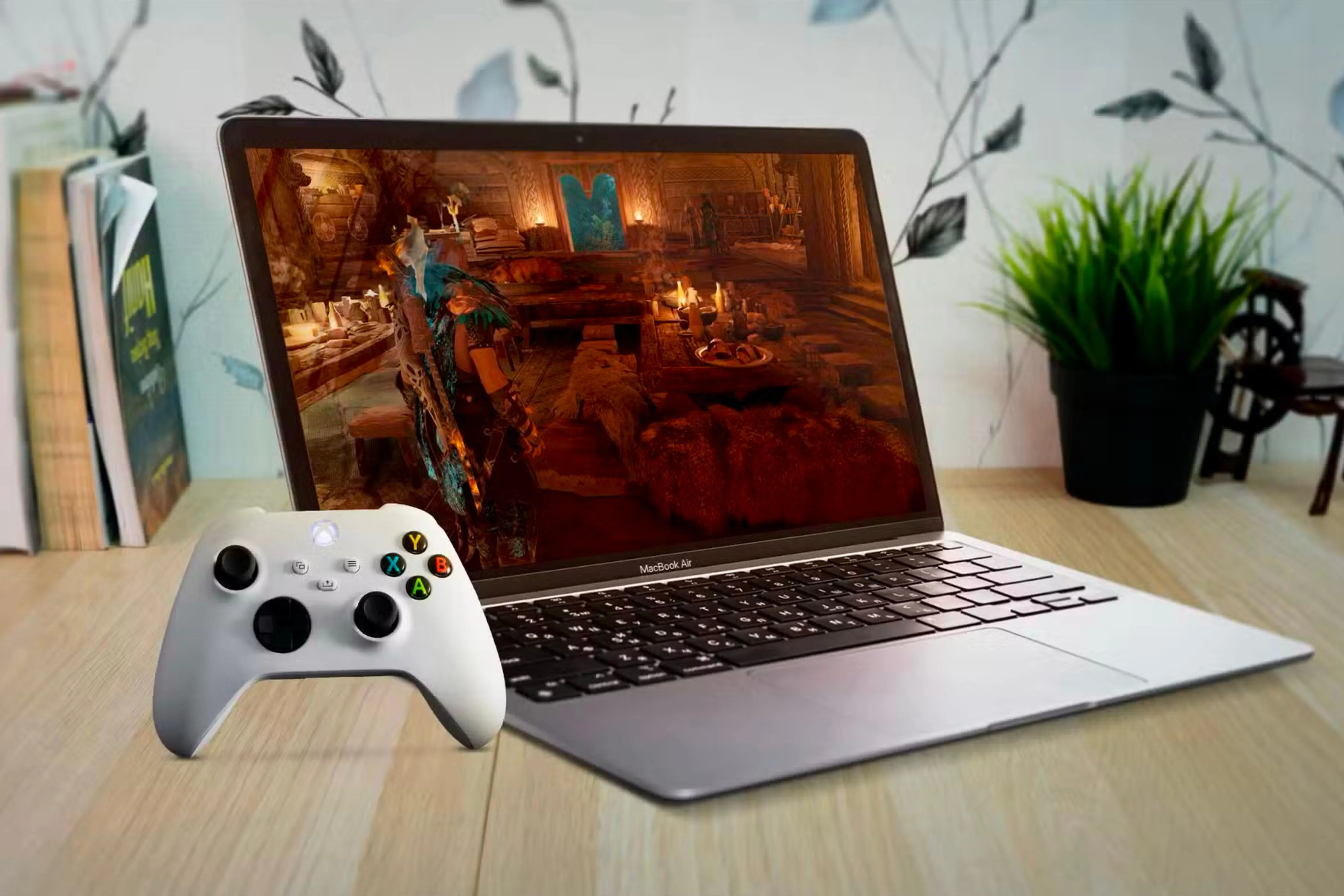 Người dùng đang chơi game trên MacBook Air với tay cầm Xbox.