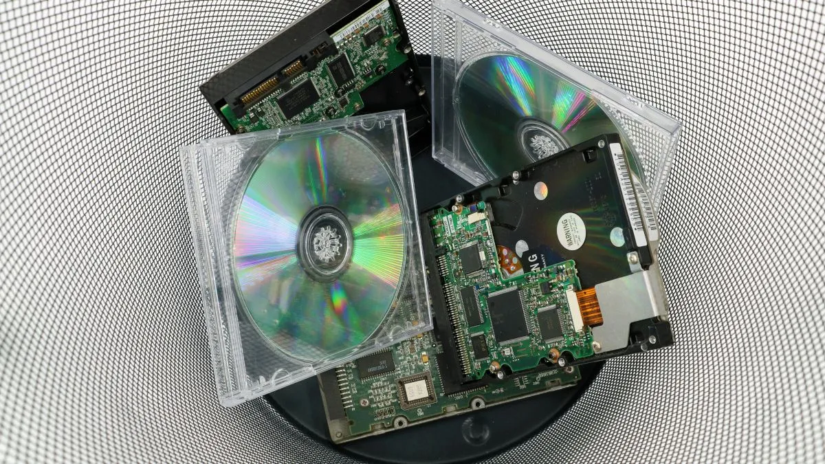 Hình ảnh đĩa CD cũ và linh kiện máy tính bị vứt bỏ, minh họa khái niệm &quot;abandonware&quot; và nguồn gốc của nó
